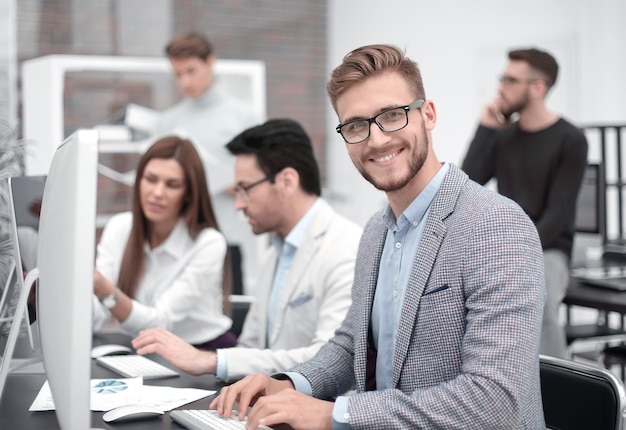 Smiling businessman in the workplace people and technology