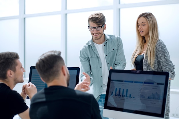 Smiling businessmen talking about eligible investment manager presenting financial report showing good work results to satisfied boss pointing on paper offering deal discussing new project