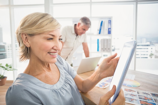 Smiling businesswoman holding a tablet