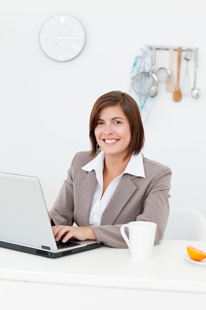 Smiling businesswoman working on her laptop 