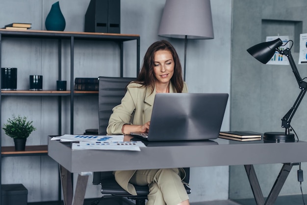 Smiling businesswoman working with laptop