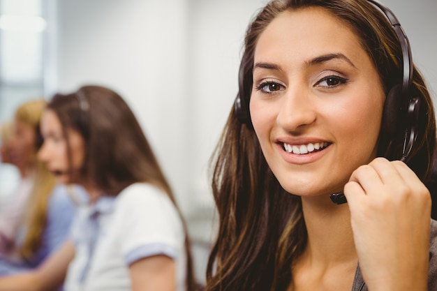 Smiling call centre agent talking on the headset