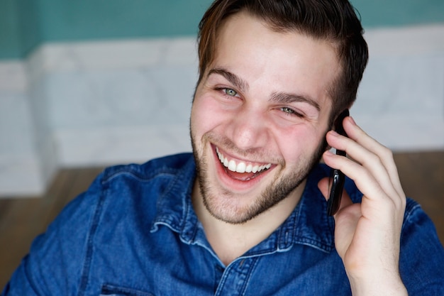 Smiling and calling on mobile phone