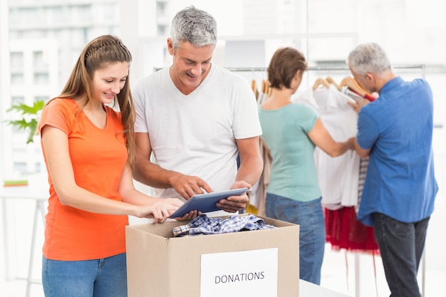 Photo smiling casual business people sorting donations