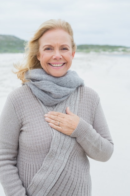 Smiling casual senior woman at beach