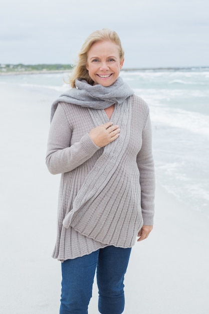 Smiling casual senior woman at beach