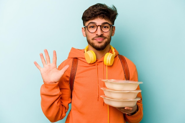 Smiling cheerful showing number five with fingers