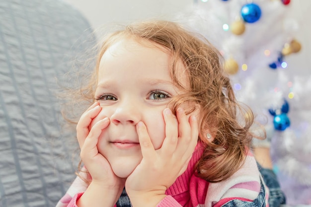 A smiling child on the background of a Christmas tree Holidays and events