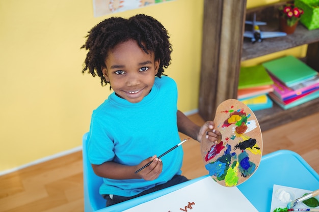 Smiling child creating a picture