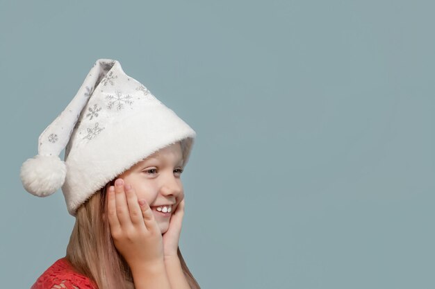 A smiling child in a Santa Claus hat Christmas Holidays and events Copy space