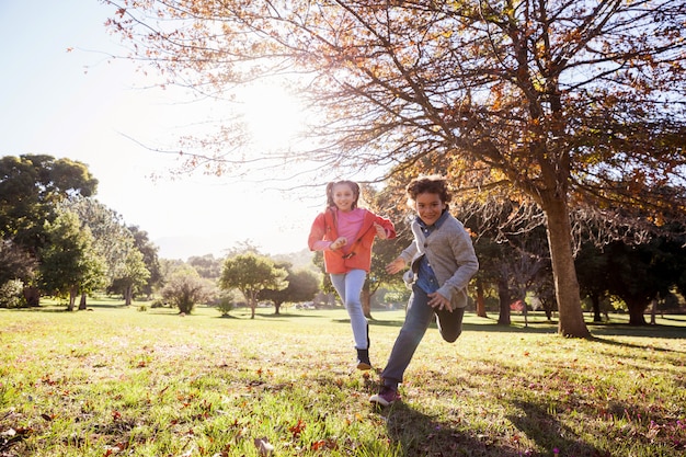 Smiling children running in park