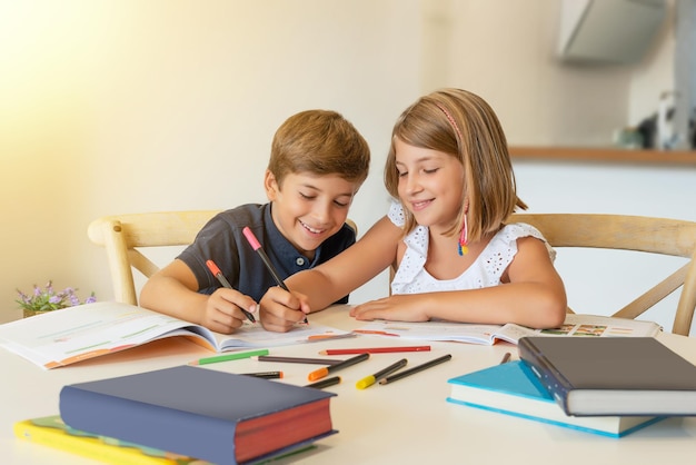 Smiling children studying at home Kids doing homework in the classroom and helping each other