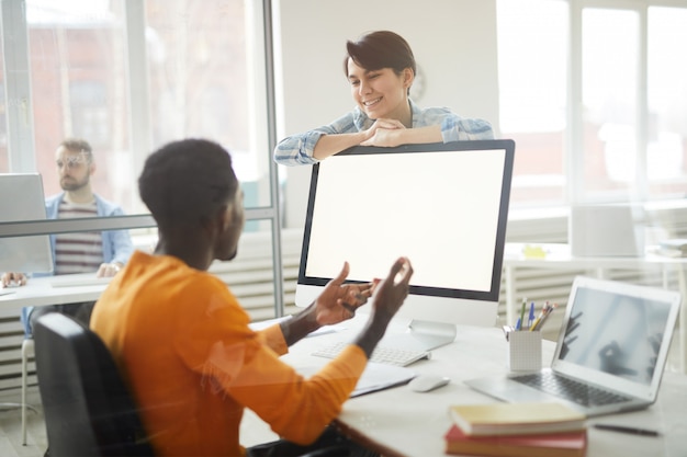 Smiling Colleagues Chatting in Office