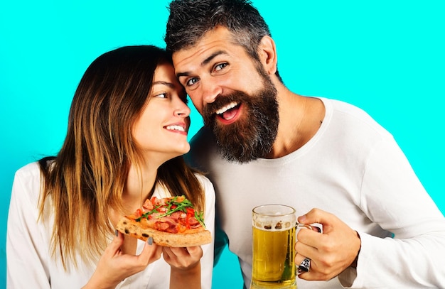 Smiling couple eating pizza and drinking beer happy family enjoying fast food together