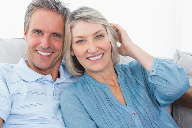 Smiling couple on their couch