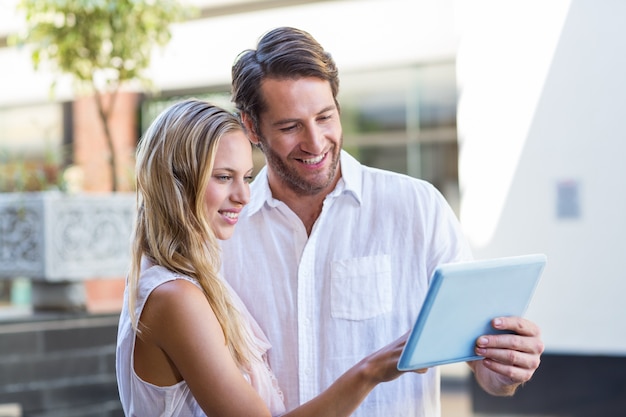 Smiling couple using tablet computer