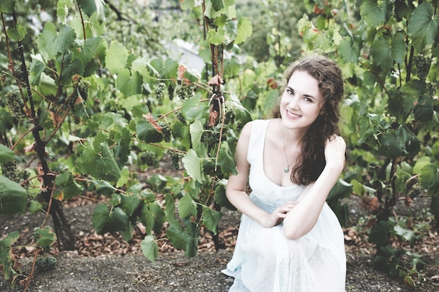 Smiling curly hair brunette in vineyard