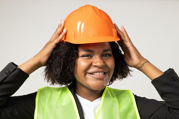 Smiling curly woman in helmet on white background