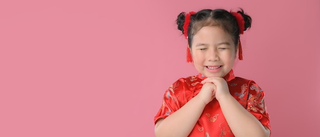 Smiling cute asian little girls in red chinese traditional dress.Happy Chinese new year concept.