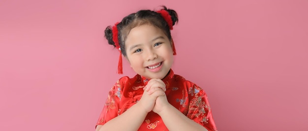 Smiling cute asian little girls in red chinese traditional dress.Happy Chinese new year concept.