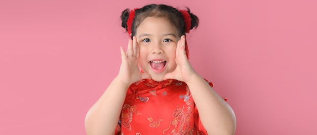 Smiling cute asian little girls in red chinese traditional dress.Happy Chinese new year concept.