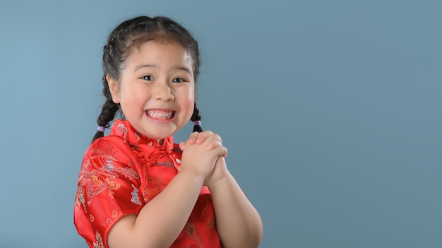 Smiling cute asian little girls in red chinese traditional dress.Happy Chinese new year concept.