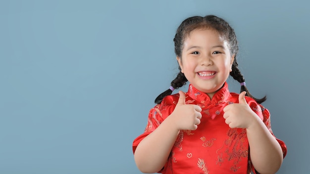 Smiling cute asian little girls in red chinese traditional dress.Happy Chinese new year concept.