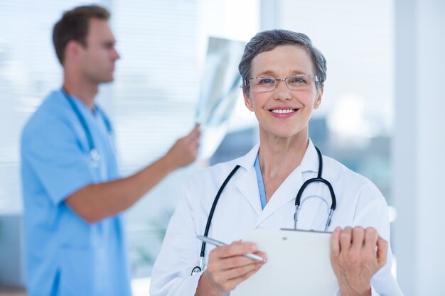 Smiling doctor holding a clipboard