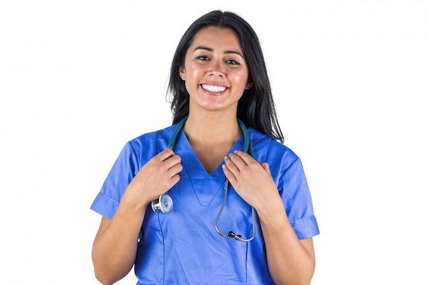 Smiling doctor with her hands holding her stethoscope