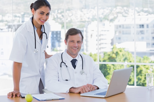 Smiling doctors posing together in their office