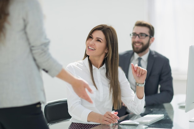 Smiling employees talking in the workplace