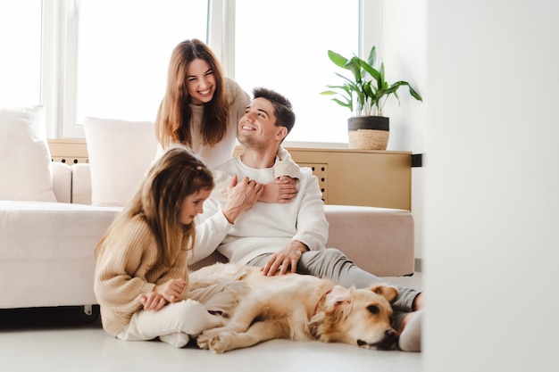 Smiling family young mother father and little daughter relaxing together woman hugging man