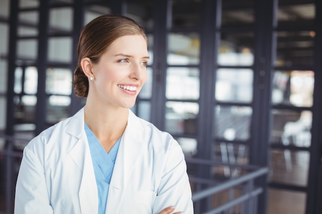 Smiling female doctor looking away 