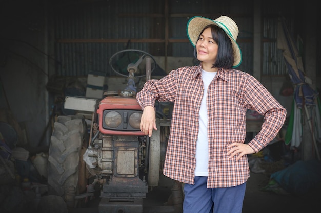 Smiling female farmer beside a tractor