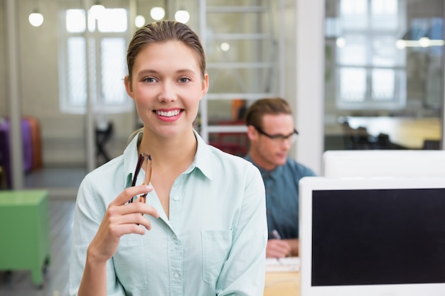 Smiling female photo editor in office