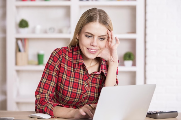 Smiling female using laptop