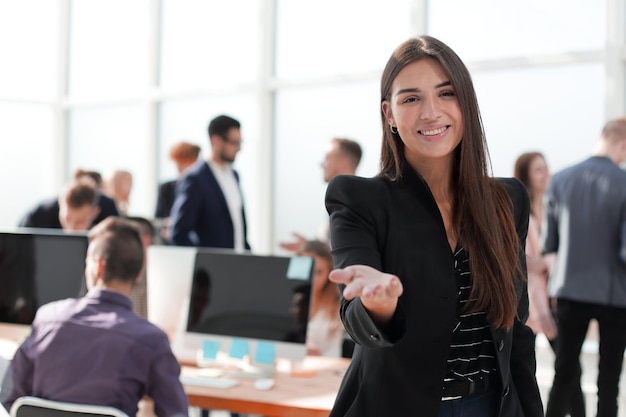 Smiling friendly business woman on the background of the office