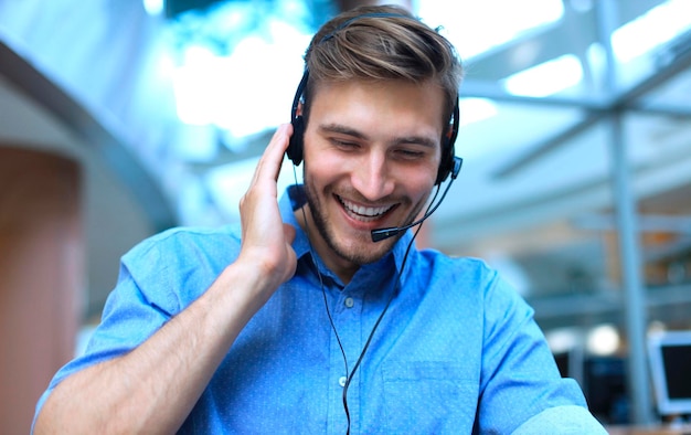 Smiling friendly handsome young male call centre operator