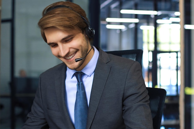 Smiling friendly handsome young male call centre operator