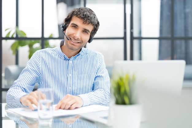 Smiling friendly handsome young male call centre operator