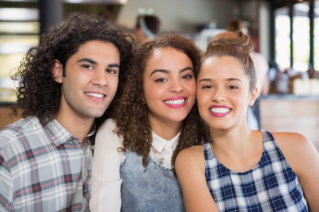 Smiling friends sitting at restaurant