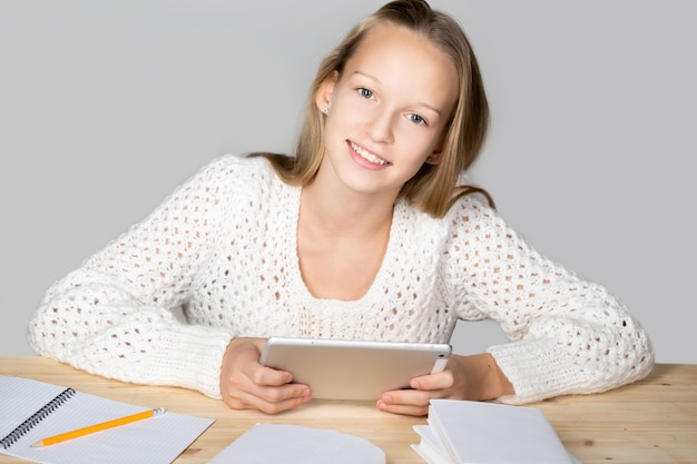 Smiling girl looking at a tablet