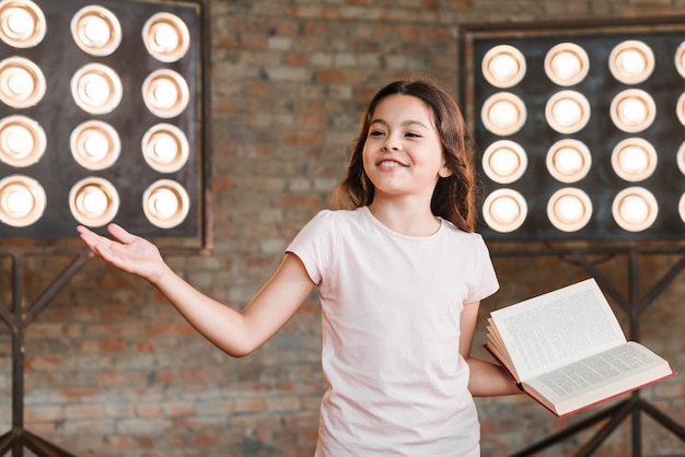 Smiling girl standing in front of stage light giving her performance