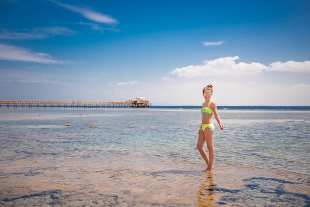 Smiling girl standing in warm sea