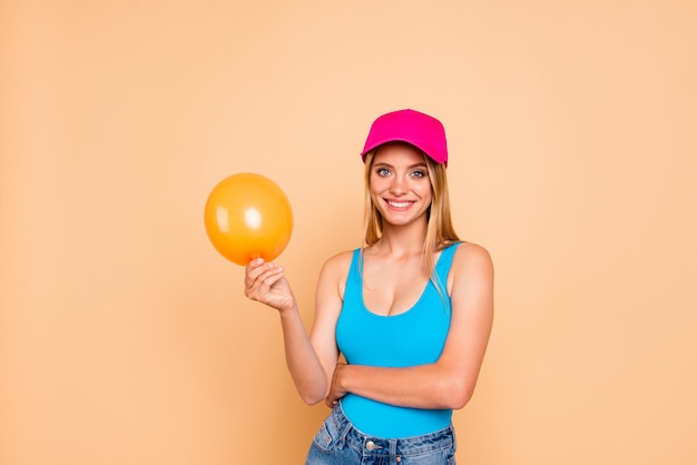 Smiling girl wearing casualclothes holding yellow air baloon