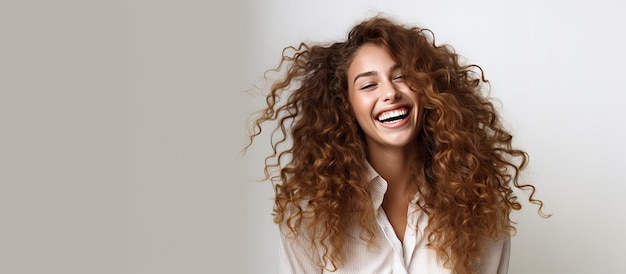 Smiling girl with curly hair joyfully White studio background