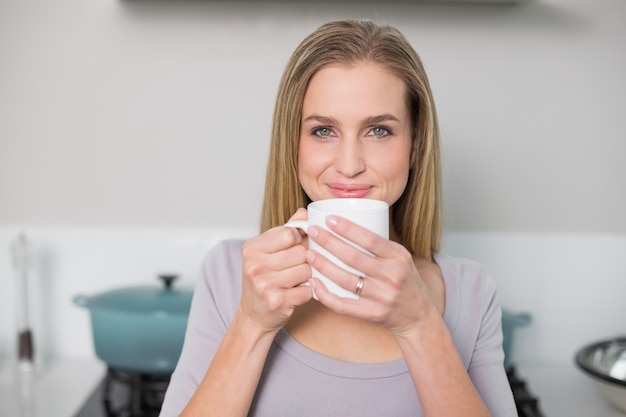 Smiling gorgeous model holding mug