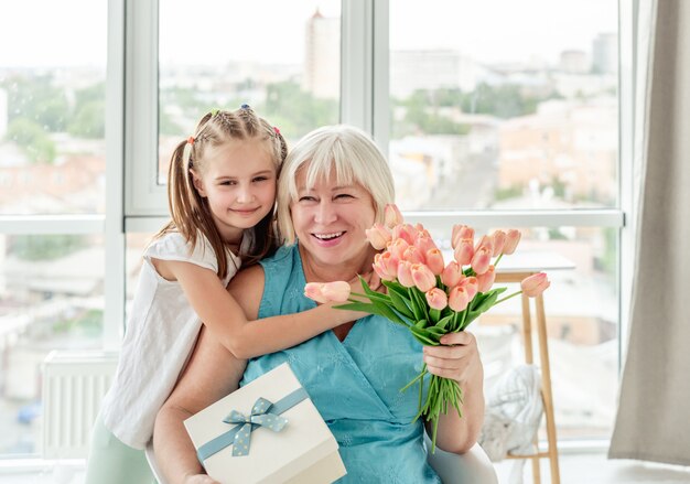 Smiling granny with presents from granddaughter