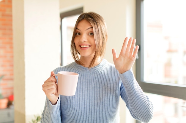 smiling happily and cheerfully, waving hand, welcoming and greeting you, or saying goodbye