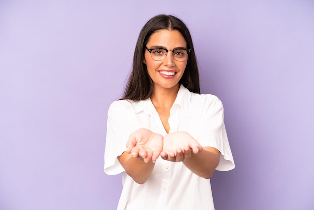 Smiling happily with friendly confident positive look offering and showing an object or concept